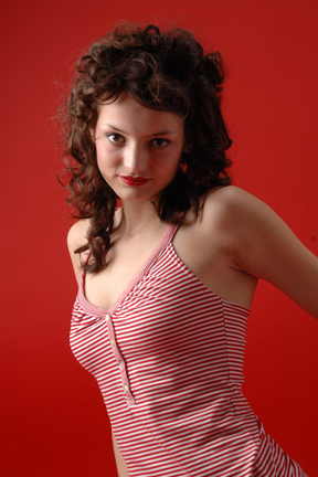 girl in red on red background in model pose